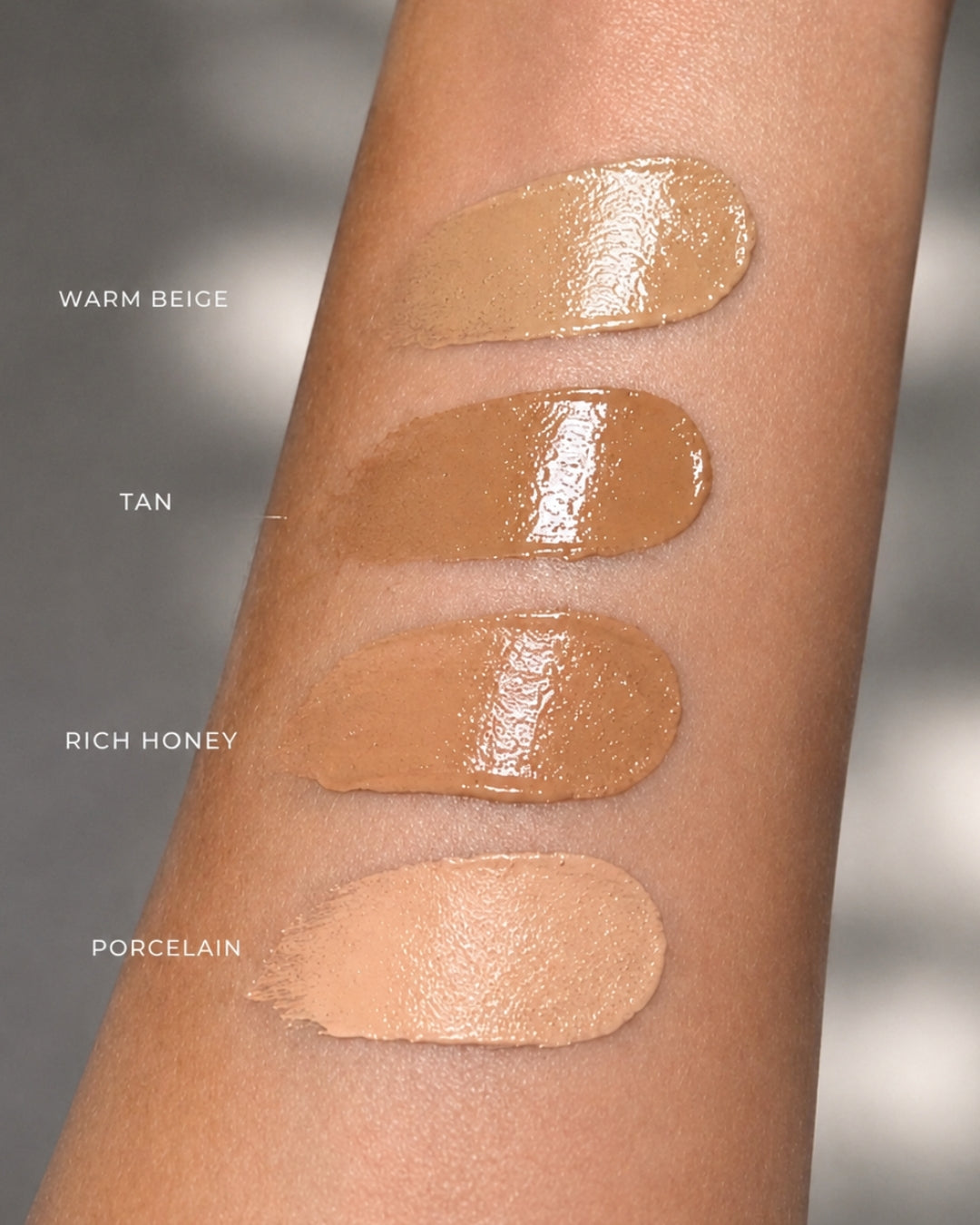 Katherine Art Sheer Skin Tint SPF55 shade swatches on skin featuring Porcelain, Warm Beige, Tan and Rich Honey for different skin tones.