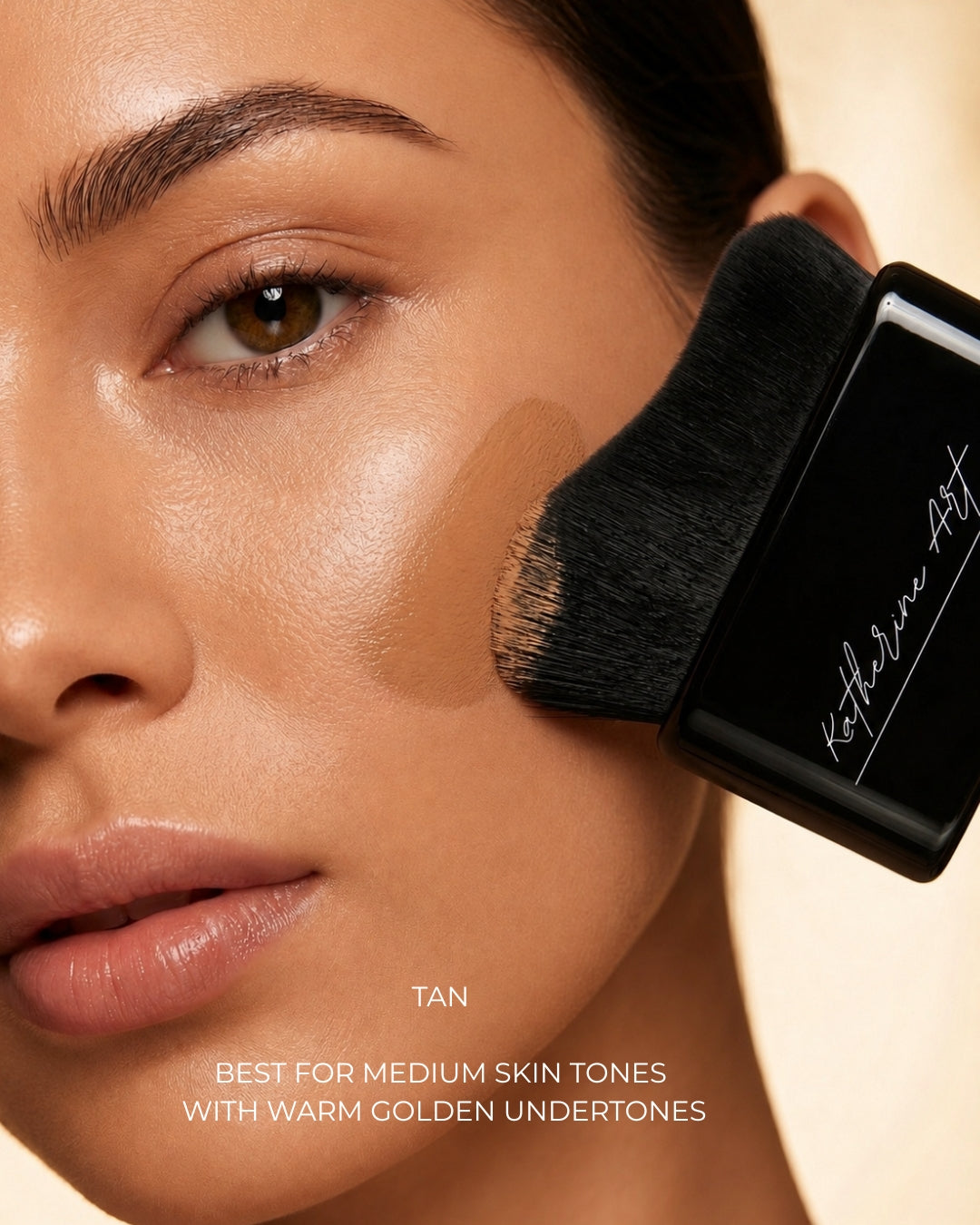 Model applying Katherine Art Sheer Skin Tint SPF55 in Tan using the Katherine Art Kabuki Brush, showcasing lightweight buildable coverage with a natural radiant finish for medium skin tones.