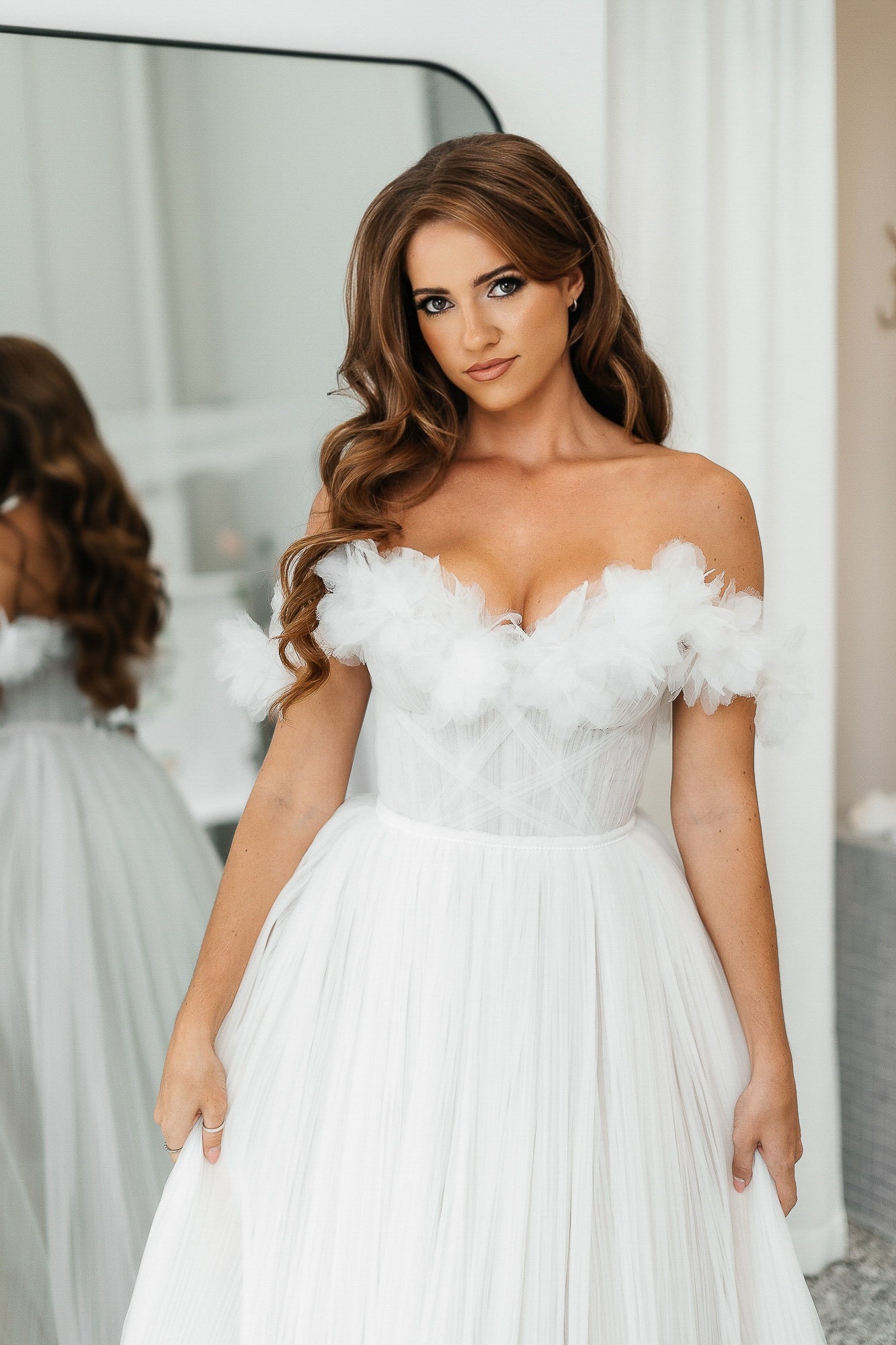 Soft glam bridal makeup with voluminous hairstyle and flawless skin, elegant wedding look with mirror reflection