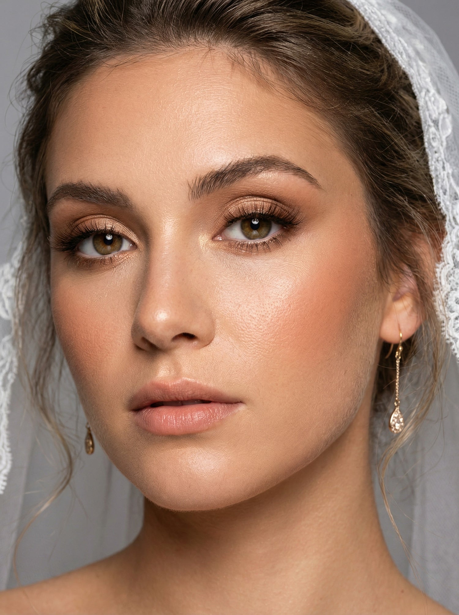 Natural bridal eye makeup with warm tones and subtle lash definition 