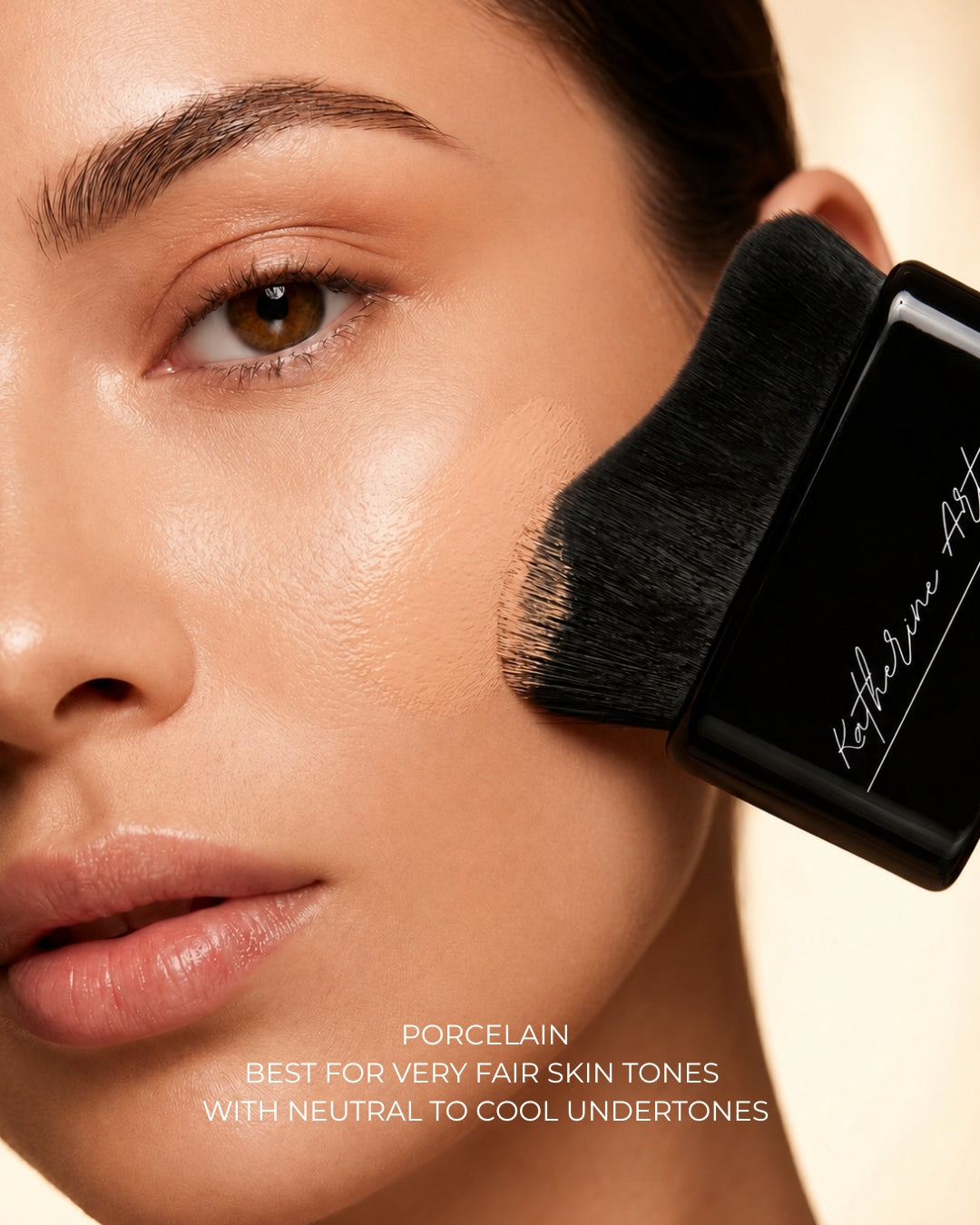Model applying Katherine Art Sheer Skin Tint SPF55 in Porcelain using the Katherine Art Kabuki Brush, showcasing lightweight coverage with a natural radiant finish for very fair skin tones.