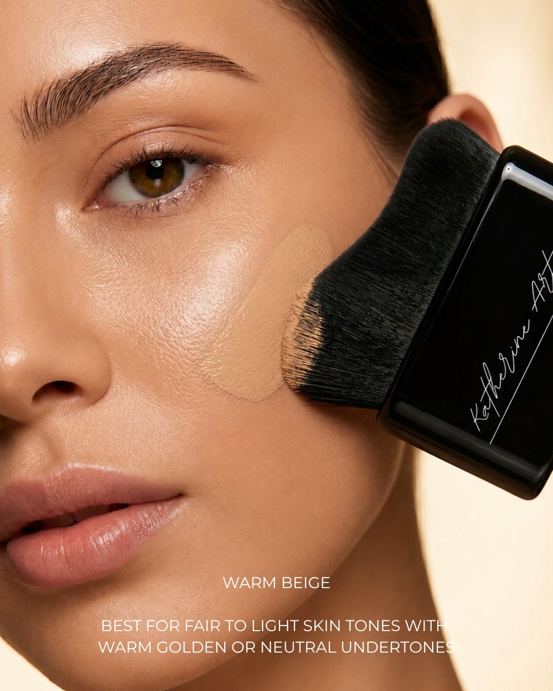 Model applying Katherine Art Sheer Skin Tint SPF55 in Warm Beige using the Katherine Art Kabuki Brush, showcasing lightweight buildable coverage with a natural radiant finish for fair to light skin tones.