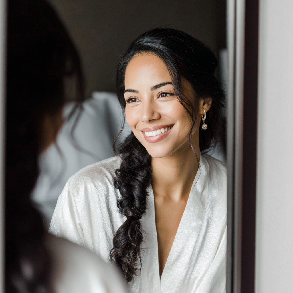 Luxury bridal morning moment with bride in robe, soft-focus radiant complexion and relaxed elegant styling
